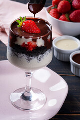 Beautiful bowl of vanilla ice cream with chocolate cake and strawberry fruit on top
