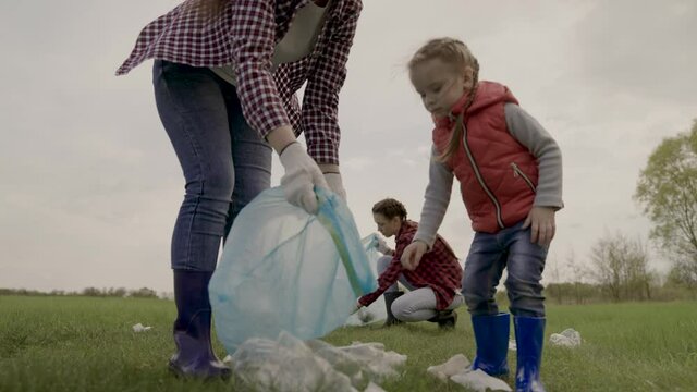 kid collecting trash volunteer teamwork. child group happy family on collects garbage plastic trash waste bottles trash. environmental happy family a ecology teamwork volunteer awareness pollution
