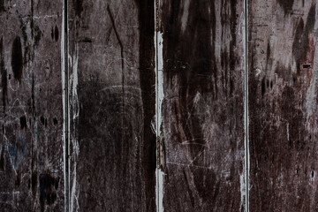Texture of rural stained exterior vertical oak planks of country barn. Old dirty rough of gnarled surface wooden panel parquet.Rustic messy grungy lumber fence of hard laths for 3D siding style design