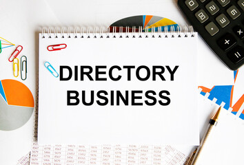 In the notebook text DIRECTORY BUSINESS, next to the diagram, calculator, pen, screech.