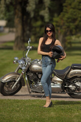 Naklejka na ściany i meble Portrait of young woman on a motorcycle
