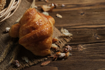 Croisant on wooden background with copy space, for bread advertising.