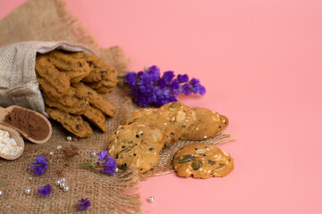 Whole grain cookies with cocoa snack in the sack on pink background. The coppy space on the right.