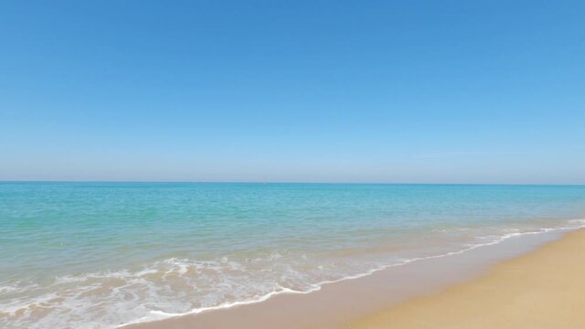 Cyan gradient sea water n calm ocean wave crashing Tropical summer sandy beach on beautiful sunny clear blue sky background in bright sunlight n sunshine day at Phuket Thailand, 4k cinemagraphs b-roll