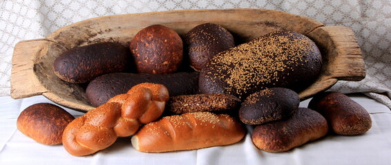 Still life with different types of bread: black, rye, white bread, bread with seeds. bread and wheat ears. 