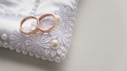 Beautiful golden wedding rings lying on top of each other, close-up.
