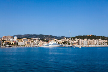 Fototapeta na wymiar View of the bay of Palma de Mallorca with luxury yachts, buildings, mountains.