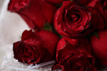 Bride Red flower bouquet in a white net close up