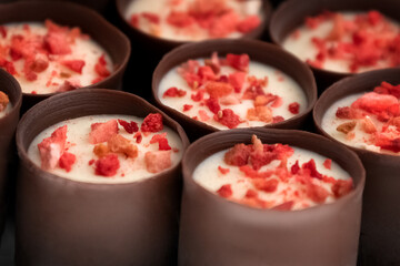 Chocolate candies with fruit sprinkles on top sweet background