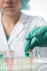 Pharma female tech works in laboratory. Unrecognisable Caucasian woman, young adult in protective...