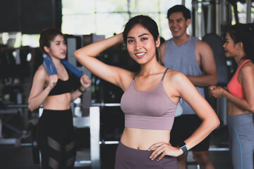 An Asian woman wearing sportswear Standing crossed in a fitness.