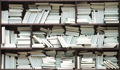 Bookcase with white color books in library, bookstore or home. - Powered by Adobe