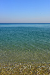 pebbly seascape, background blue clouds. Pruva Beach, Istanbul.