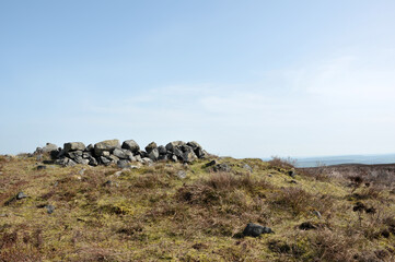 the exposed stones at the top of a cairn known as the millers grave on midgley moor in calderdale west yorkshire