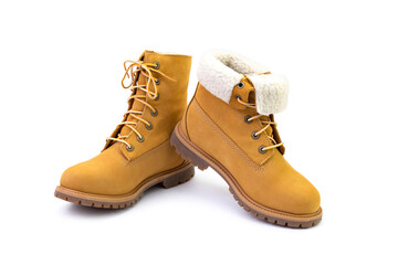 Pair of short yellow suede boots isolated on white background. Fashion and shopping concept