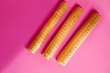Homemade Waffle cones with condensed milk, isolated on pink background