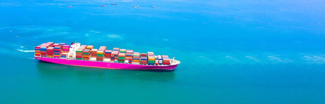 Containers cargo ship at industrial import-export port transport goods around world, global transportation and logistic business.Oversea international Business.