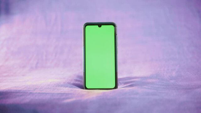 smartphone avec fond vert sur fond isol&eacute; violet