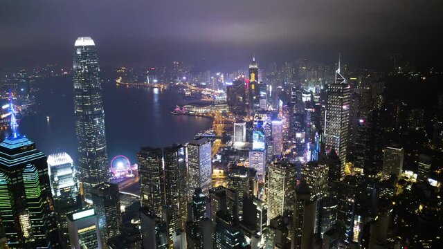 Aerial view from flying drone of Central of Hong Kong at night time. modern skyscrapers and tall edifices of megapolis, urban transportation system. 