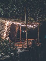 Thai hut turn on the lights at night near riverside