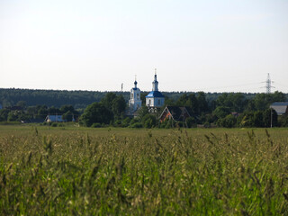 Fototapeta na wymiar russian field in summer with a church on the background