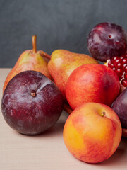 Still life of fresh fruit with pomegranate, grapes, pears and plums