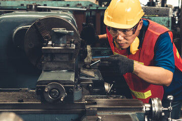 Skillful factory worker or engineer do machine job in manufacturing workshop . Industrial people...