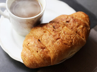 Cappuccino and croissant so close