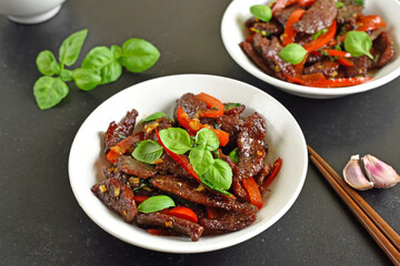 Thai beef stir-fry with pepper and basil in bowl