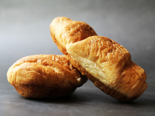 Delicious fresh croissants on a black background