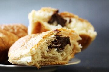 Croissant with chocolate on a black background