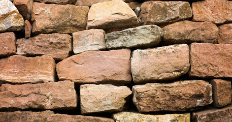 Background stone wall made of red stones