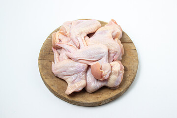 Raw chicken wings on a white background. Fresh chicken meat. Healthy diet. Heap of raw chicken wings