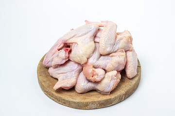 Raw chicken wings on a white background. Fresh chicken meat. Healthy diet. Heap of raw chicken wings