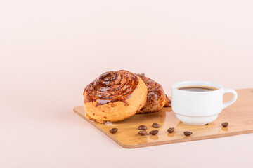 Two sweet cinnamon rolls and a cup of coffee.
