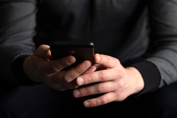 Young businessman holding and using smart phone dialing touch screen cell phone in office. business, lifestyle, technology and social media network concept