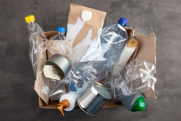 Recycling and ecology concept. Sorting household waste - plastic, paper, metal, captured from...