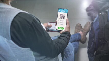 Covid-19 vaccination passport on smart phone screen,woman traveller sits at the airport holding coronavirus health certificate and boarding pass,travel safety measures green card
