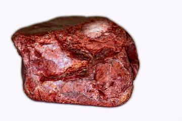fragment of stone found in nature in the mountains. close up. contains details, red stone. 