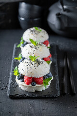 Unique sush burger with blueberries and raspberries sprinkled with sesame.