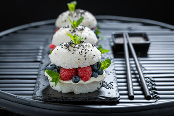 Exquisite sush burger with berries and sesame sprinkled with sesame.