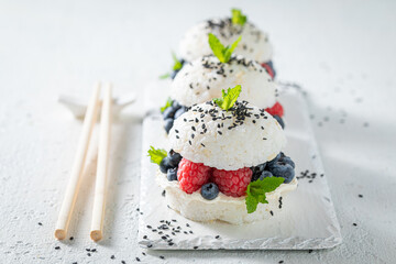 Exquisite sush burger with mascarpone and berries on stone plate.