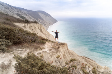 Runner standing on mountains and open arms