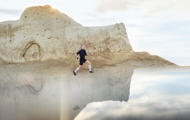 Man running in mountains on the sunrise