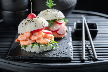 Healthy sush burger with salmon and avocado as Japanese appetizers.