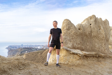 Man standing on mountains, looking on horizon