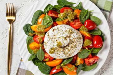 Spinach, Tomato and Burrata Salad on a plate