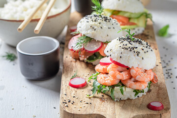 Unique sush burger with fish and shrimps as Japanese appetizers.