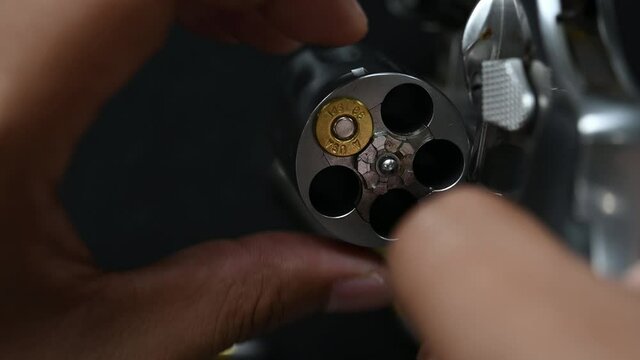Reloading bullet,The compact revolver gun, Revolver Pistol on black background.