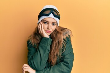 Beautiful blonde caucasian woman wearing snow wear and sky glasses thinking looking tired and bored with depression problems with crossed arms.